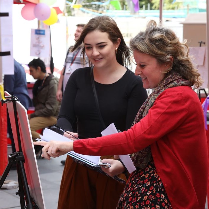 Two women look at artwork