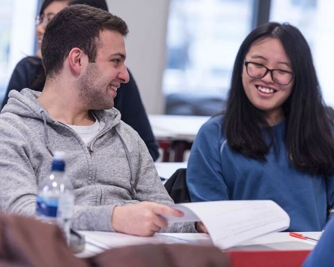 two students discussing their work